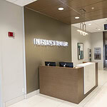 Reception desk in a modern building lobby with a sign that says 'Regency Tower'.