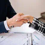 man and woman shaking hands after signing a lease